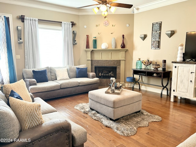 living room with ceiling fan, wood-type flooring, and crown molding