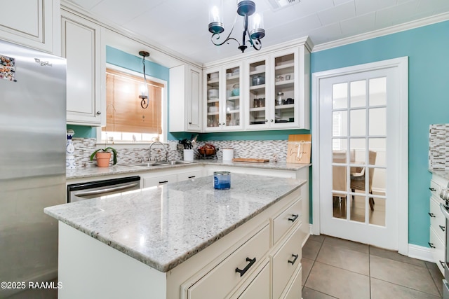 kitchen featuring decorative light fixtures, sink, decorative backsplash, and stainless steel appliances