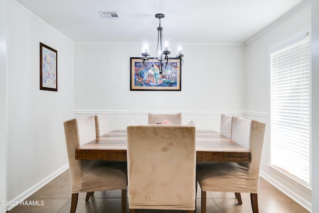 tiled dining space with breakfast area, an inviting chandelier, and crown molding