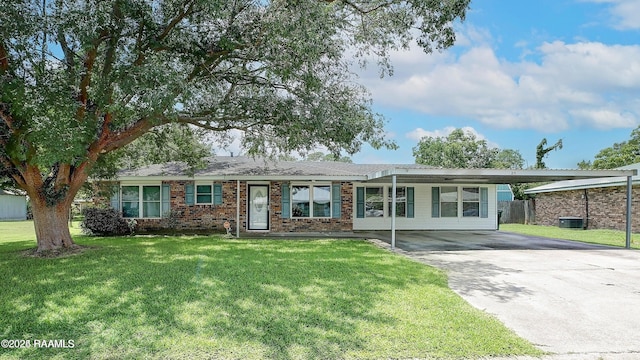 ranch-style home with a front lawn and a carport