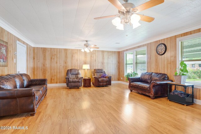 living room with ceiling fan, light wood-type flooring, and ornamental molding