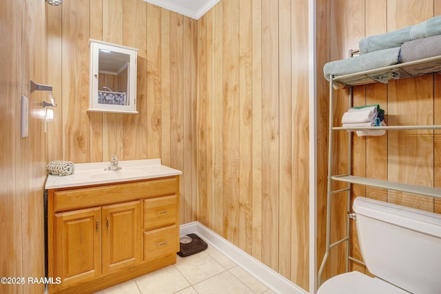 bathroom with wood walls, toilet, vanity, and ornamental molding