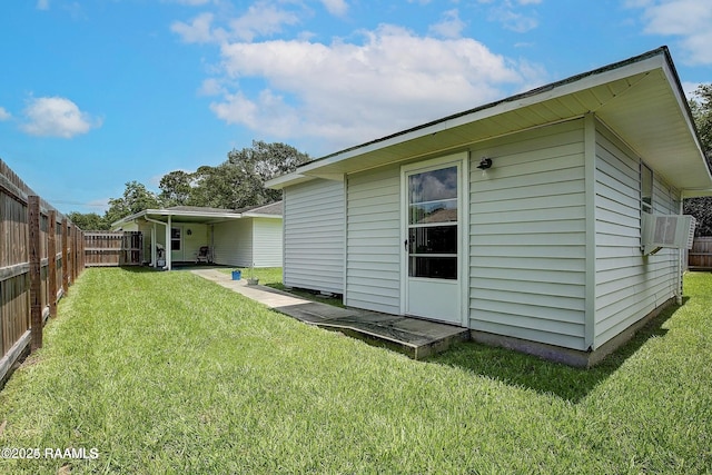 rear view of property with cooling unit and a yard