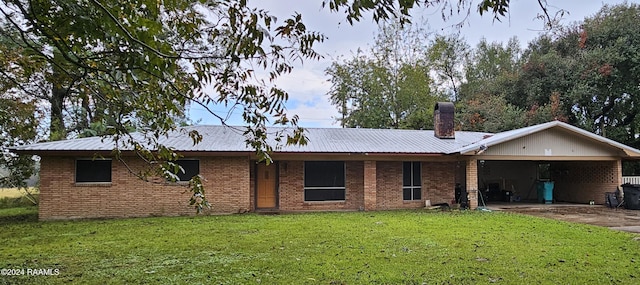 ranch-style house featuring a garage and a front lawn