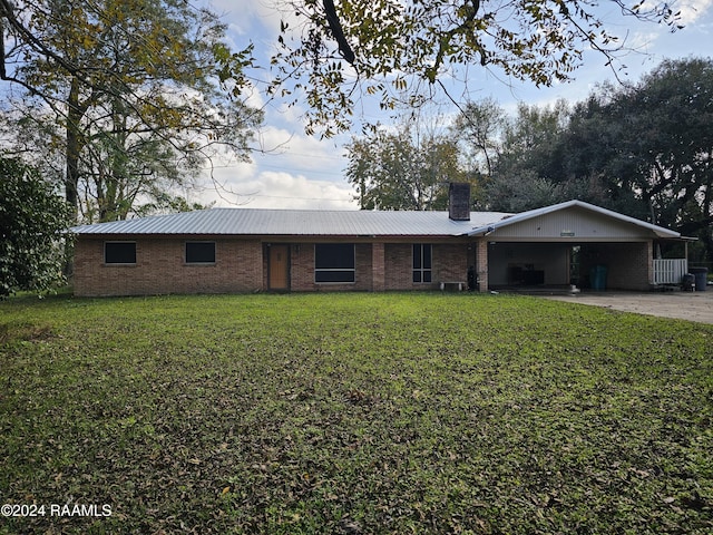 ranch-style home with a front yard and a carport