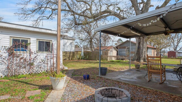 view of yard with a patio and a fire pit