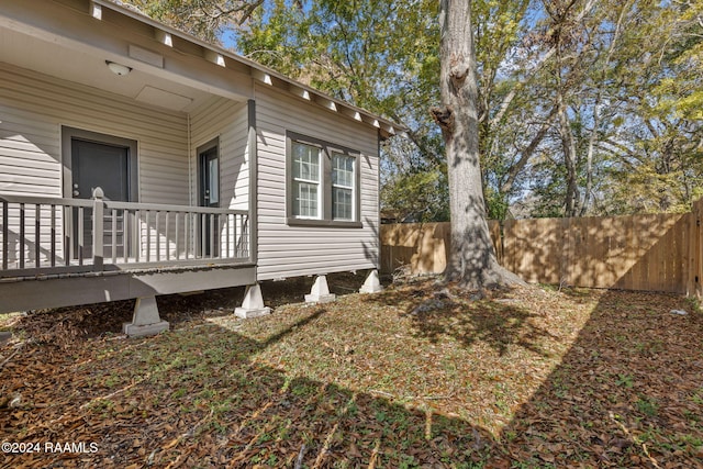 view of side of property featuring a wooden deck