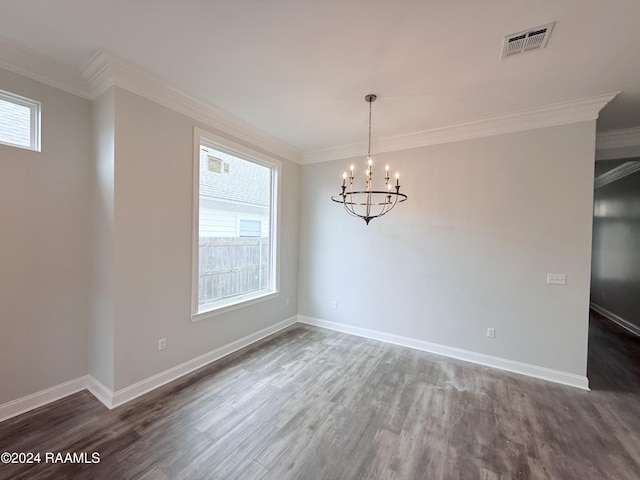 empty room featuring ornamental molding, a healthy amount of sunlight, and a chandelier