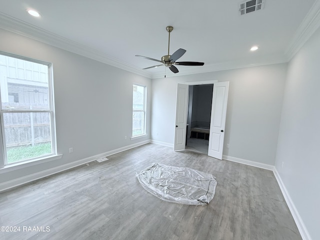 unfurnished bedroom featuring ornamental molding, ceiling fan, and light hardwood / wood-style floors