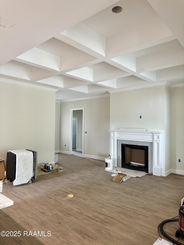 unfurnished living room featuring hardwood / wood-style floors, coffered ceiling, and beamed ceiling