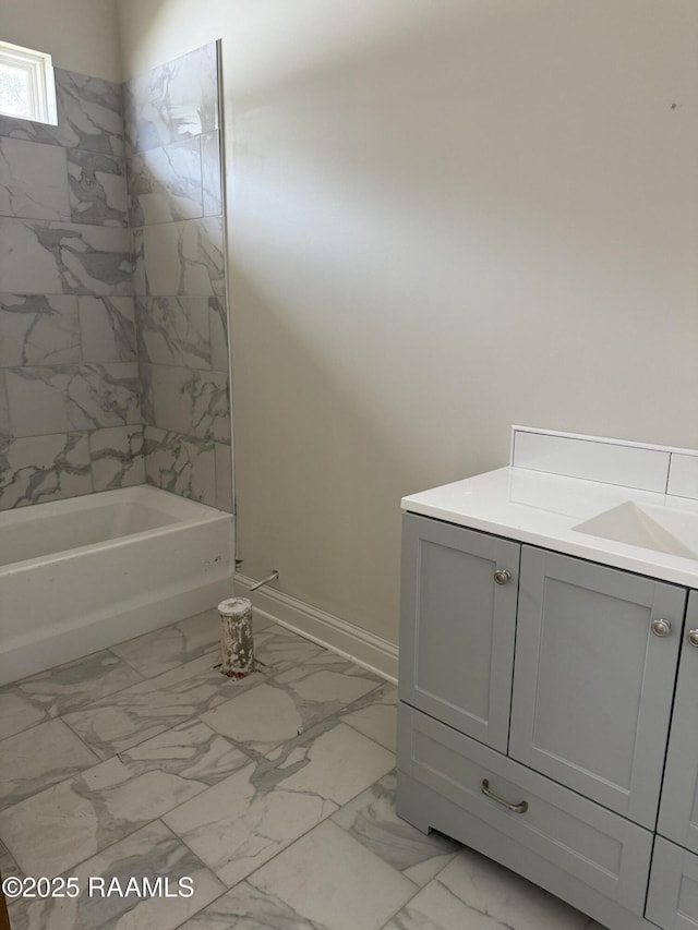 bathroom with vanity and tiled shower / bath combo