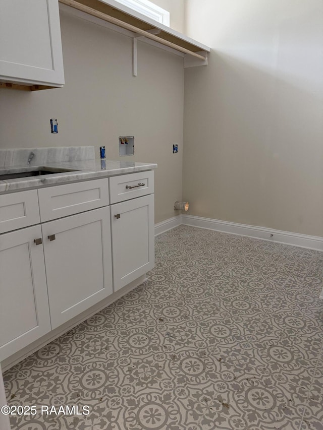 clothes washing area featuring sink, cabinets, and hookup for a washing machine