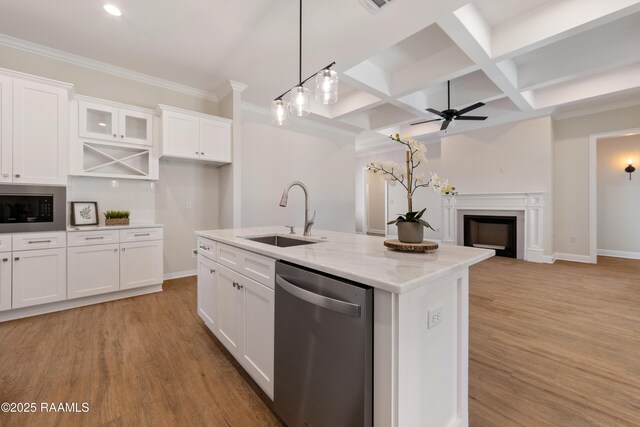 kitchen featuring a fireplace, a sink, white cabinets, appliances with stainless steel finishes, and light wood finished floors