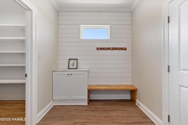 mudroom featuring crown molding, wood finished floors, and baseboards