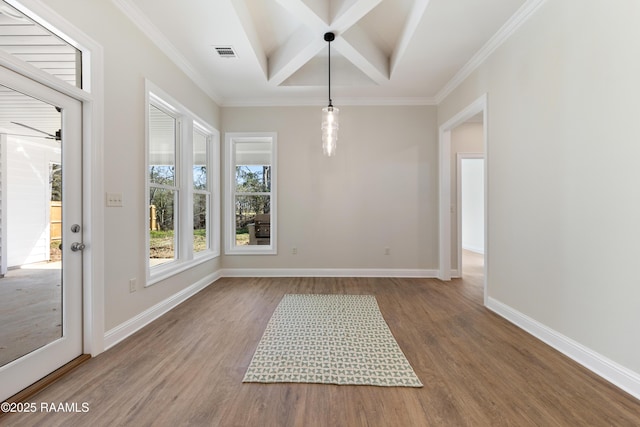 unfurnished dining area featuring baseboards, visible vents, coffered ceiling, and wood finished floors