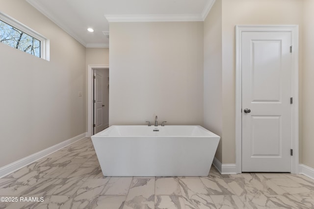 bathroom featuring a freestanding bath, marble finish floor, and baseboards