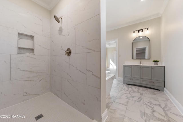 bathroom with marble finish floor, crown molding, vanity, tiled shower, and baseboards