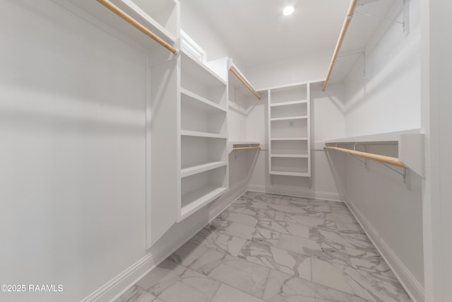 walk in closet with marble finish floor