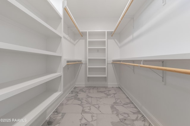 spacious closet featuring marble finish floor