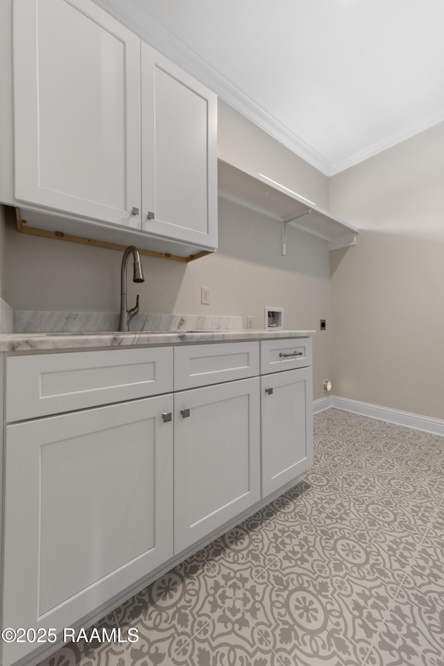 laundry area featuring washer hookup, baseboards, cabinet space, electric dryer hookup, and crown molding