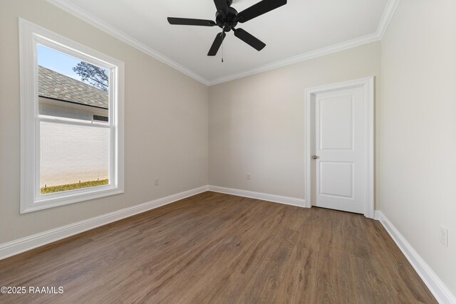 empty room with a ceiling fan, crown molding, baseboards, and wood finished floors