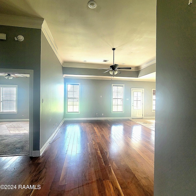 empty room with ceiling fan, hardwood / wood-style floors, and ornamental molding