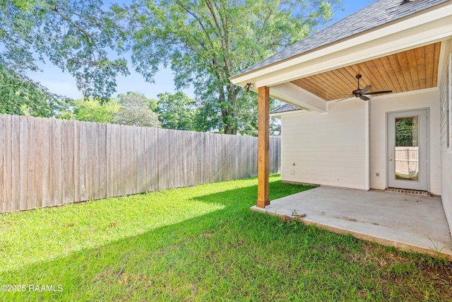 view of yard featuring a fenced backyard, ceiling fan, and a patio area