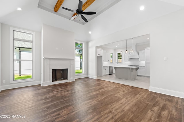 unfurnished living room featuring recessed lighting, baseboards, ceiling fan, and wood finished floors