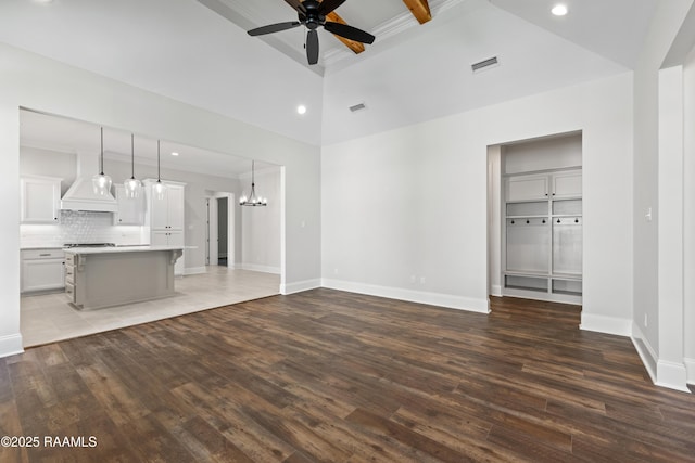 unfurnished living room featuring ceiling fan with notable chandelier, recessed lighting, wood finished floors, and visible vents