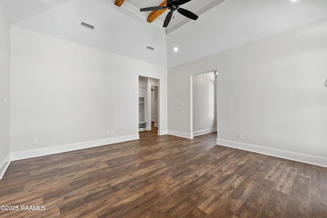 unfurnished bedroom with a towering ceiling, dark wood finished floors, and visible vents