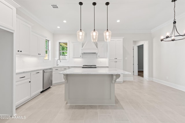 kitchen featuring white cabinets, appliances with stainless steel finishes, decorative backsplash, and an inviting chandelier