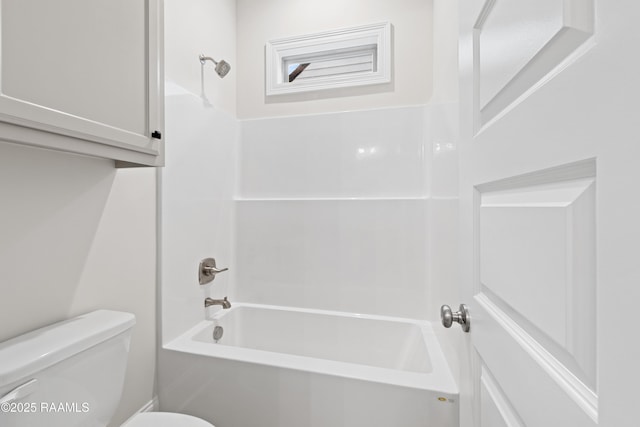 bathroom with bathtub / shower combination and toilet