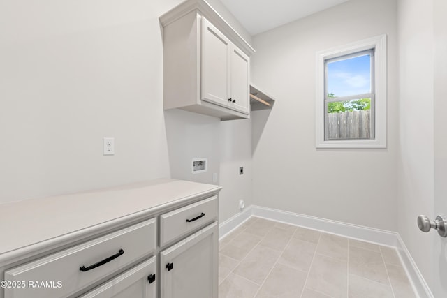laundry area with washer hookup, hookup for an electric dryer, cabinet space, light tile patterned floors, and baseboards