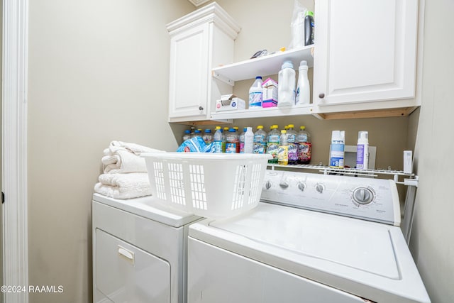 washroom featuring washer and dryer and cabinets