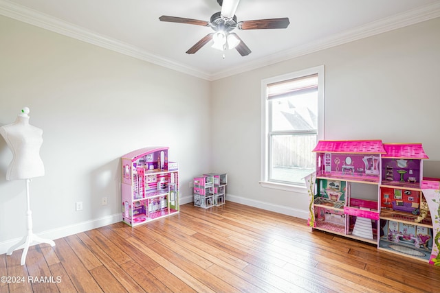 playroom with hardwood / wood-style flooring, plenty of natural light, and ornamental molding