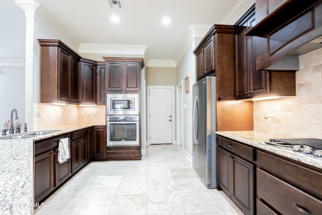 kitchen with crown molding, sink, appliances with stainless steel finishes, tasteful backsplash, and dark brown cabinetry