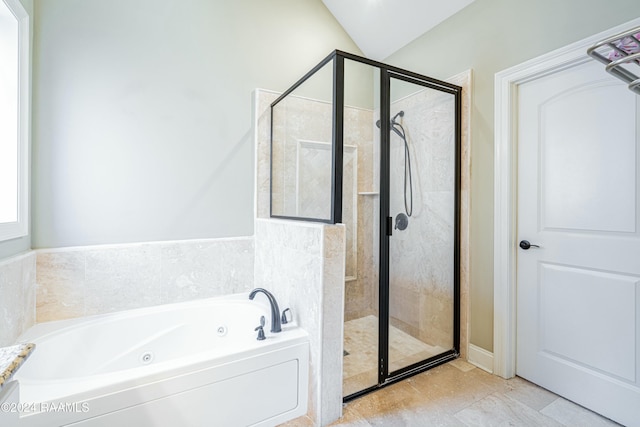 bathroom featuring separate shower and tub, tile patterned floors, and vaulted ceiling