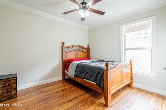 bedroom featuring light hardwood / wood-style flooring, ceiling fan, and crown molding