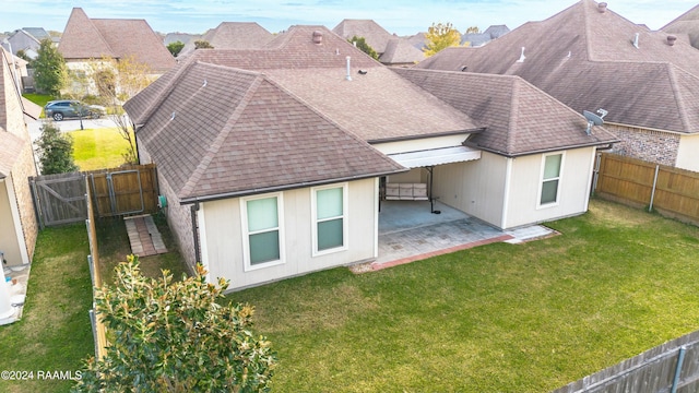 back of property featuring a yard and a patio