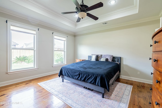 bedroom featuring multiple windows, ceiling fan, and wood-type flooring