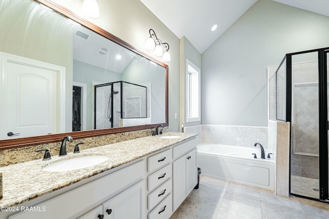 bathroom with tile patterned flooring, vanity, separate shower and tub, and lofted ceiling