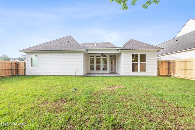 back of house featuring a patio area, a fenced backyard, a ceiling fan, and a yard