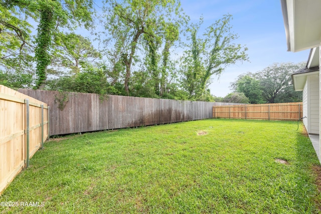 view of yard with a fenced backyard