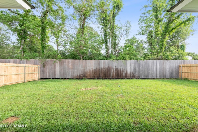 view of yard with a fenced backyard