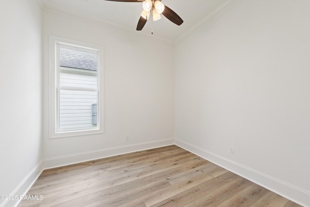 spare room with ceiling fan, light wood finished floors, baseboards, and ornamental molding