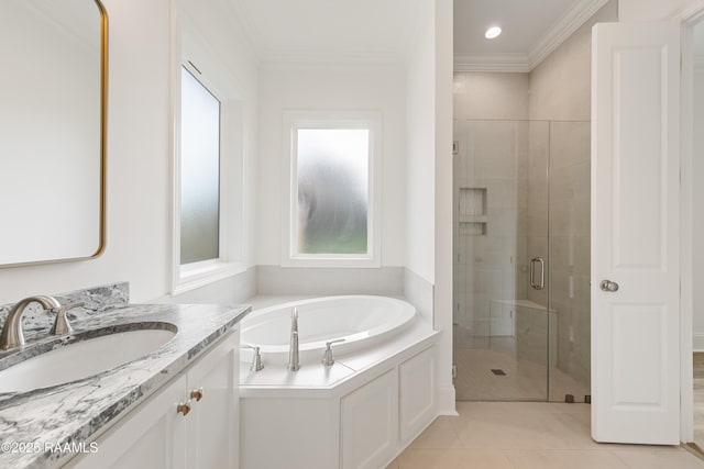 bathroom with tile patterned flooring, vanity, a bath, crown molding, and a stall shower