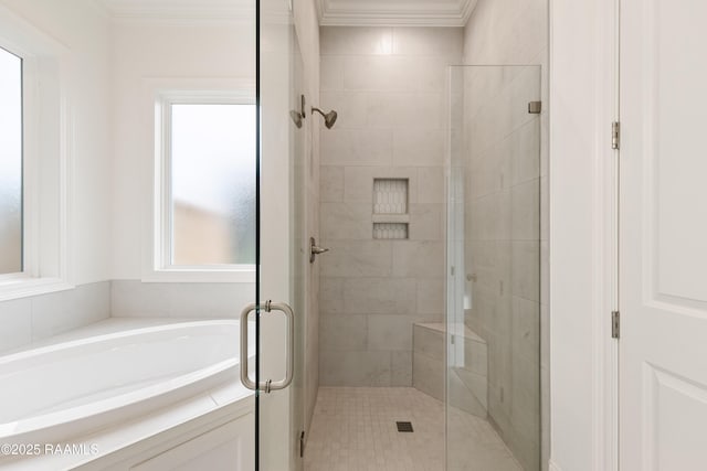 full bath featuring a garden tub, ornamental molding, and a stall shower