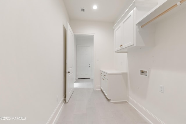 laundry area featuring baseboards, recessed lighting, hookup for a washing machine, cabinet space, and light tile patterned floors
