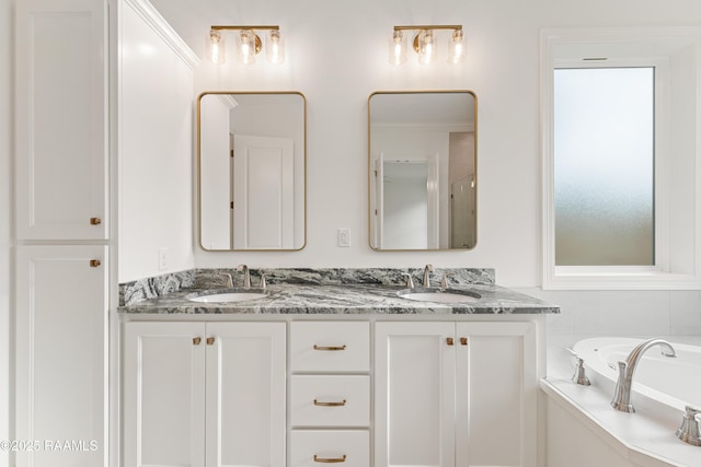 full bathroom featuring double vanity, a garden tub, and a sink