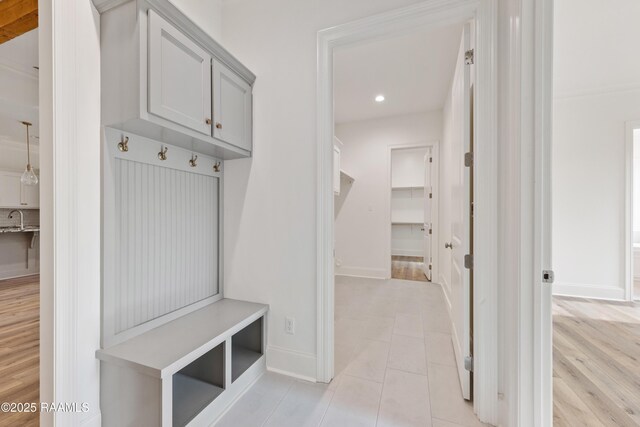 mudroom featuring light tile patterned floors, baseboards, and recessed lighting